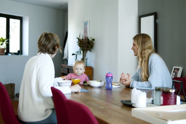 Casual family dining scene with parents and child at home in Portugal.