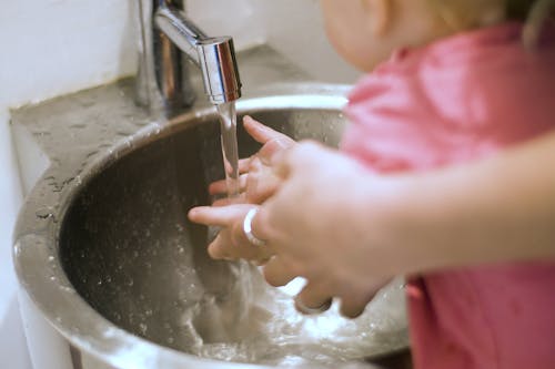Free Person and Child Washing Their Hands Stock Photo
