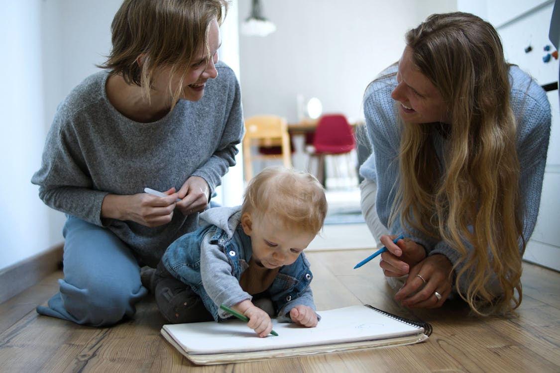 Women with Baby Writing on Notebook