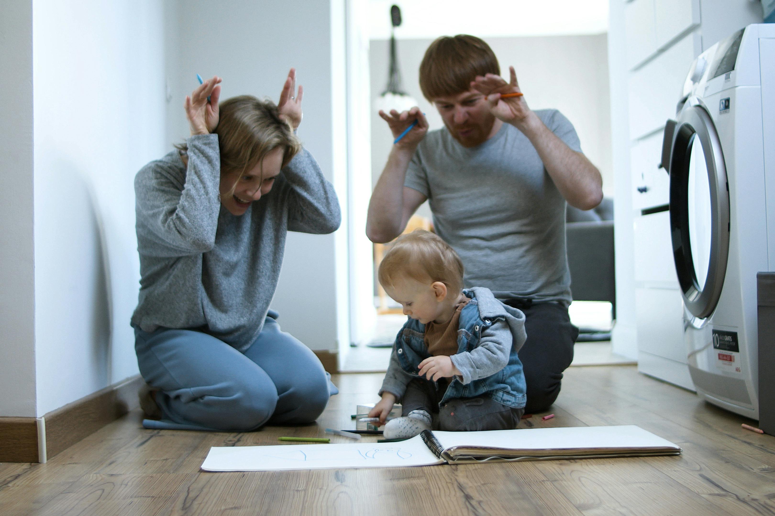 father and mother playing with their son