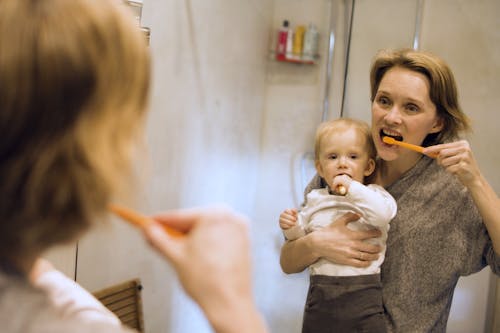Free Mother and Child Brushing Teeth Stock Photo