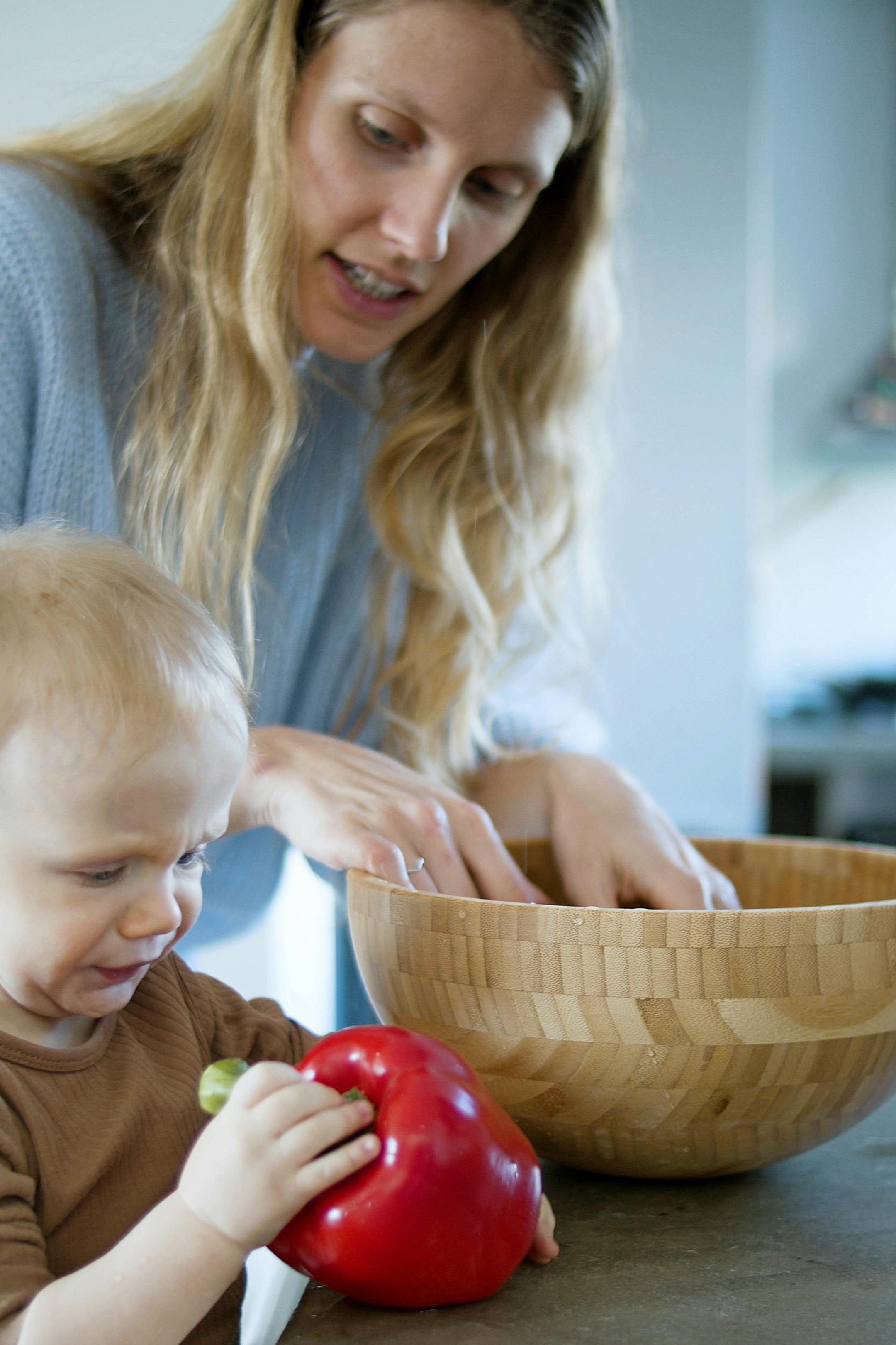 woman and child holding vegetable