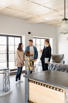 Family explores a new home with a realtor, discussing the property details.