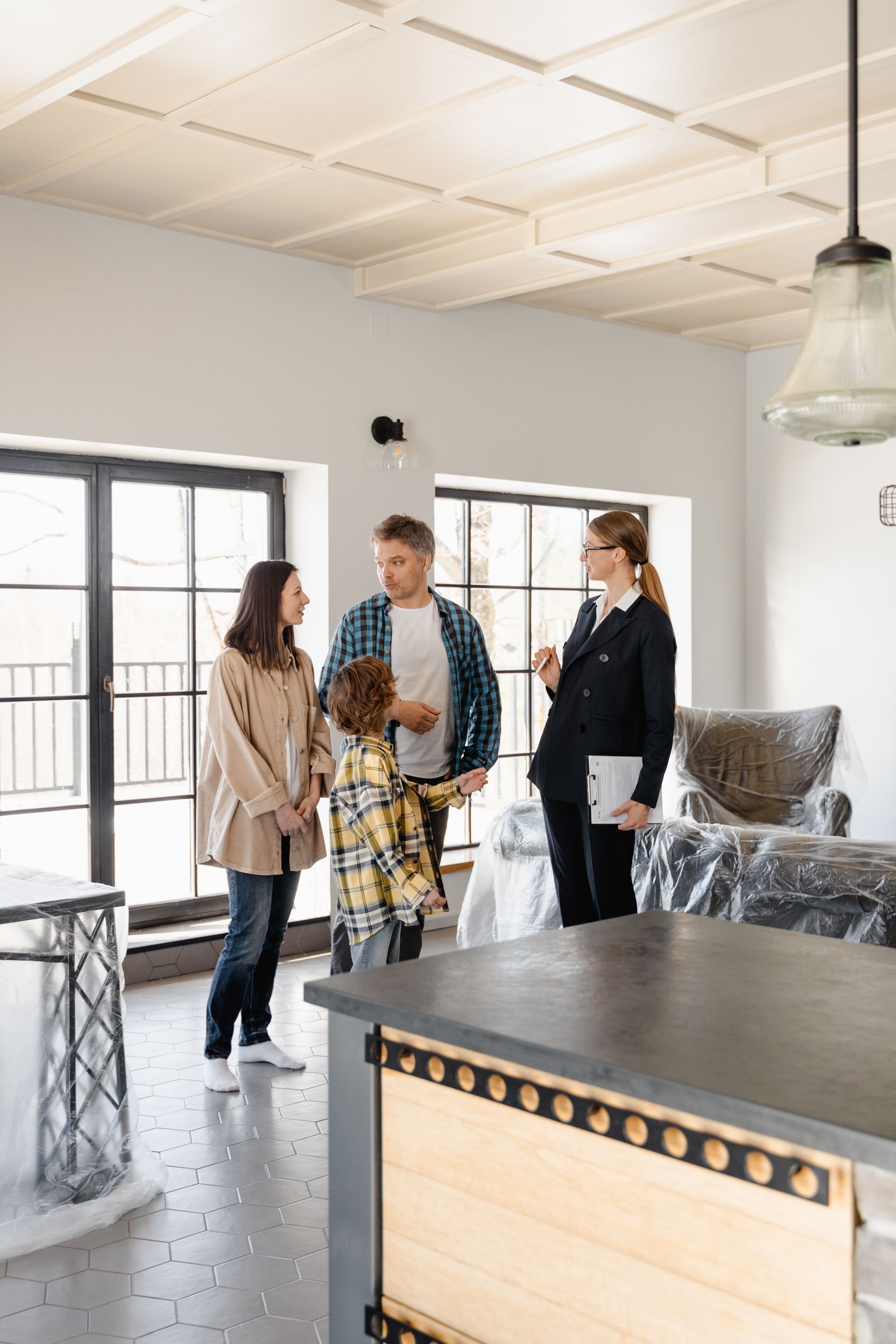 Family and property manager discussing details inside a managed home