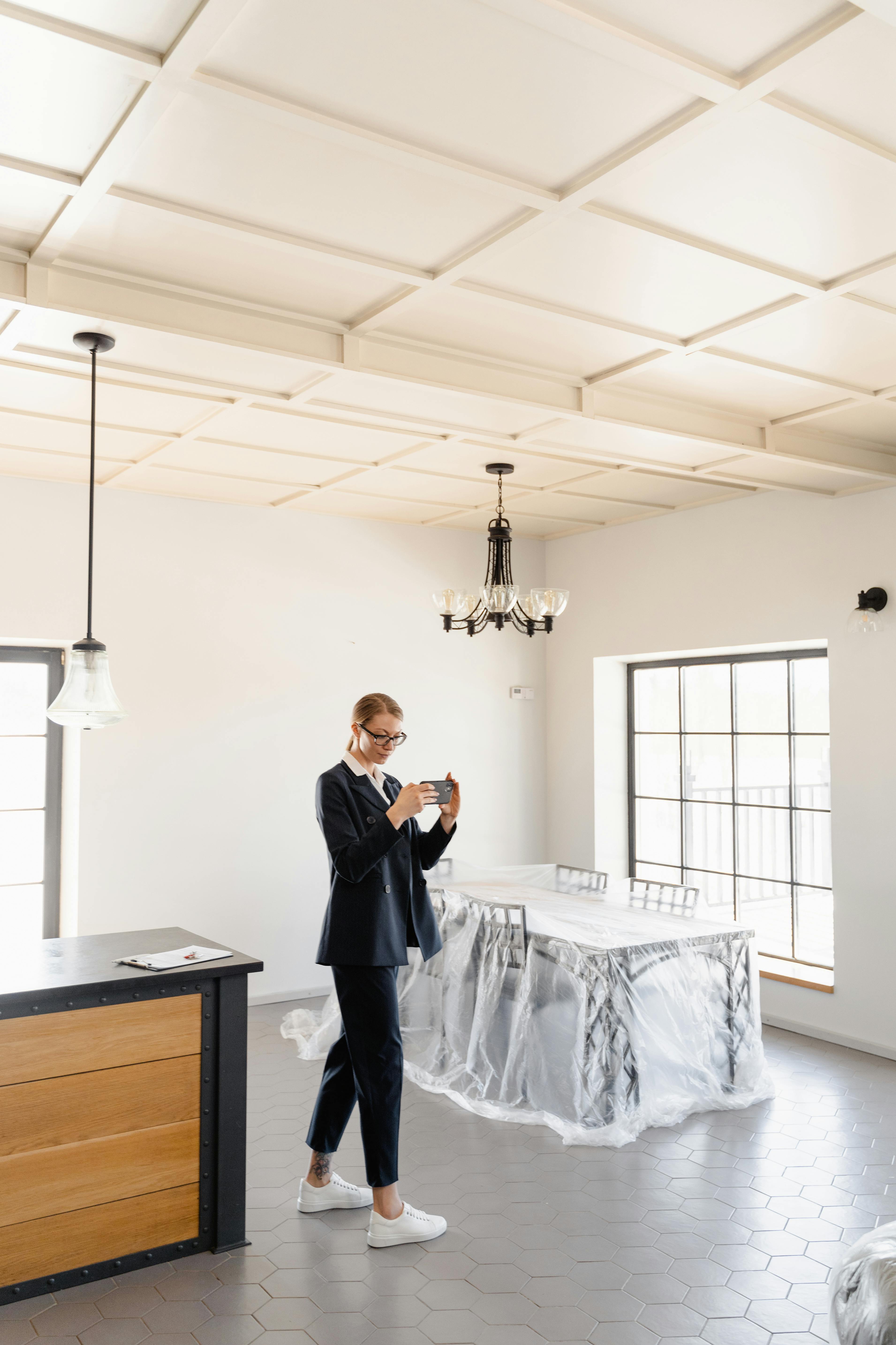 man in black suit standing beside white table