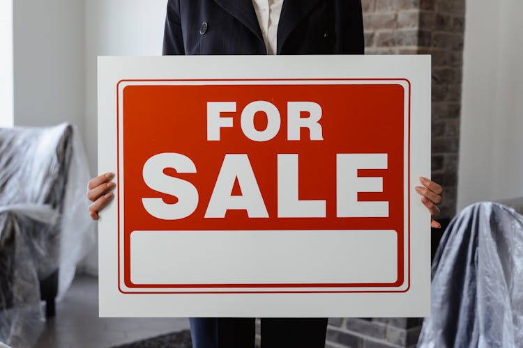 A Person Holding A Placard