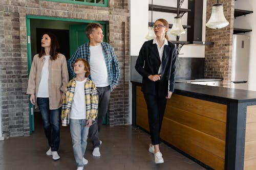 Free A Real Estate Agent Touring the Family Inside a House Stock Photo