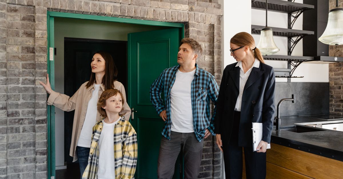 Family exploring potential new home guided by a real estate agent.