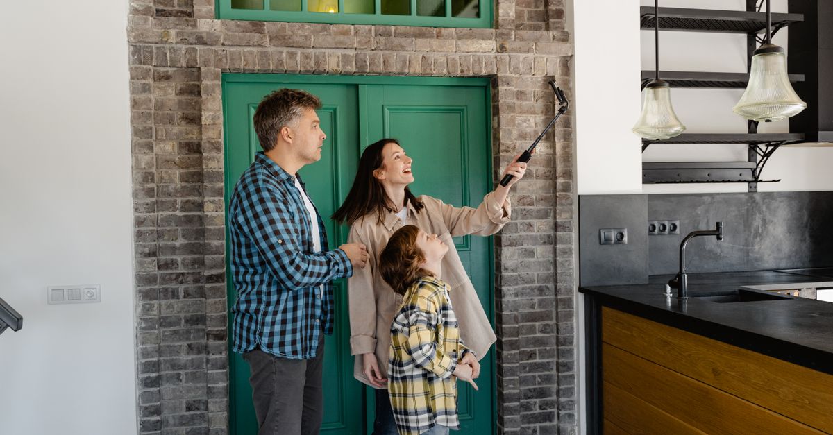 A happy family takes a selfie in their new home, capturing the joy of a new beginning.
