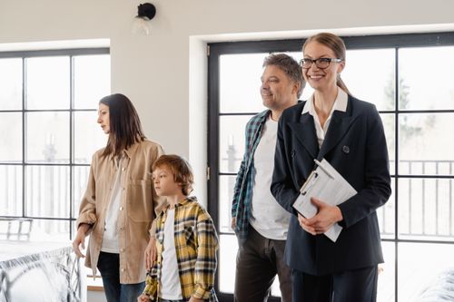 Free A family explores their new home with the help of a realtor, filled with excitement and anticipation. Stock Photo