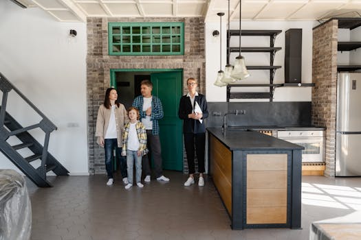 A family with a realtor viewing a modern industrial-style kitchen in a new home.
