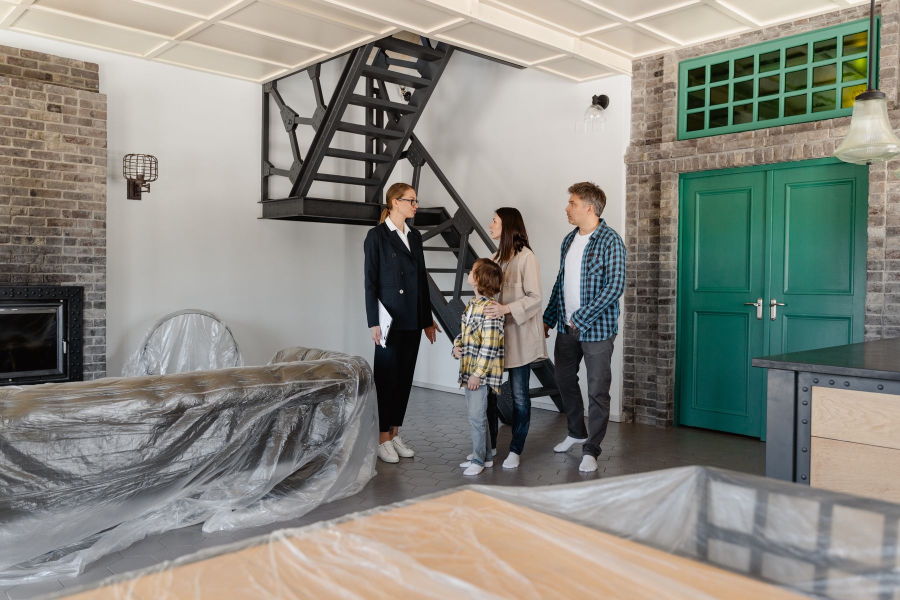 Family walking through a newly updated home with children in the background