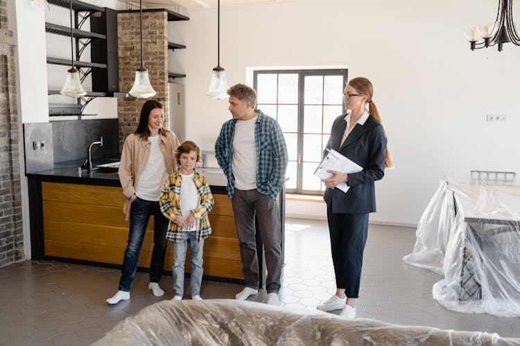 An Agent Talking To Her Clients Inside The House