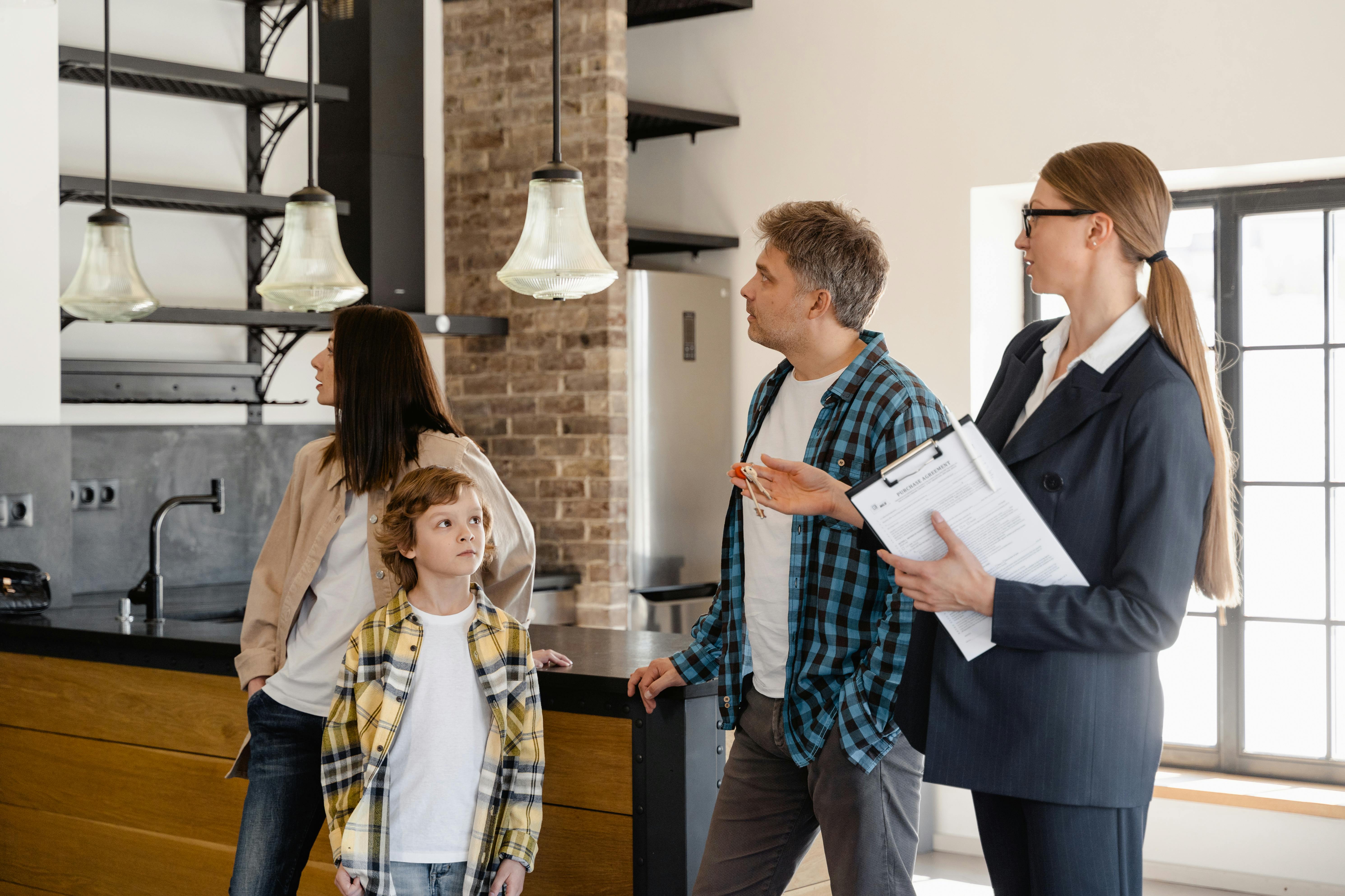 an agent touring around the prospect buyers inside the house