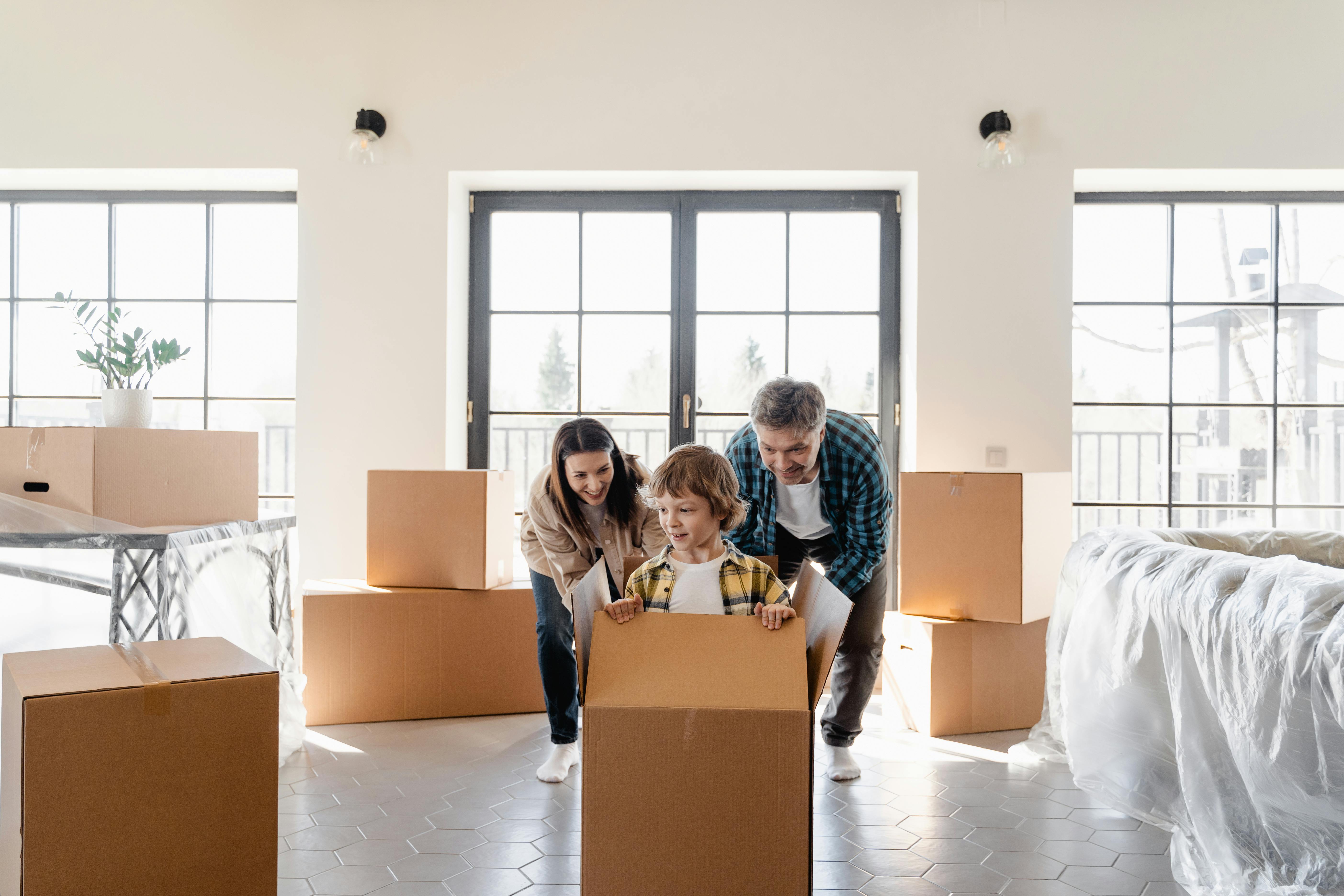 a couple looking at their son inside the box