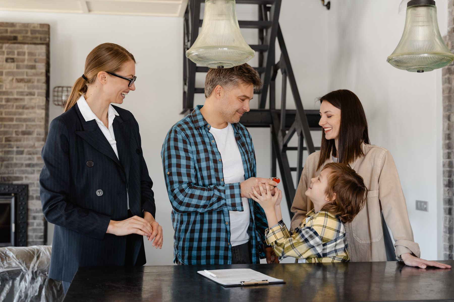 Family receiving keys during a home-financing milestone