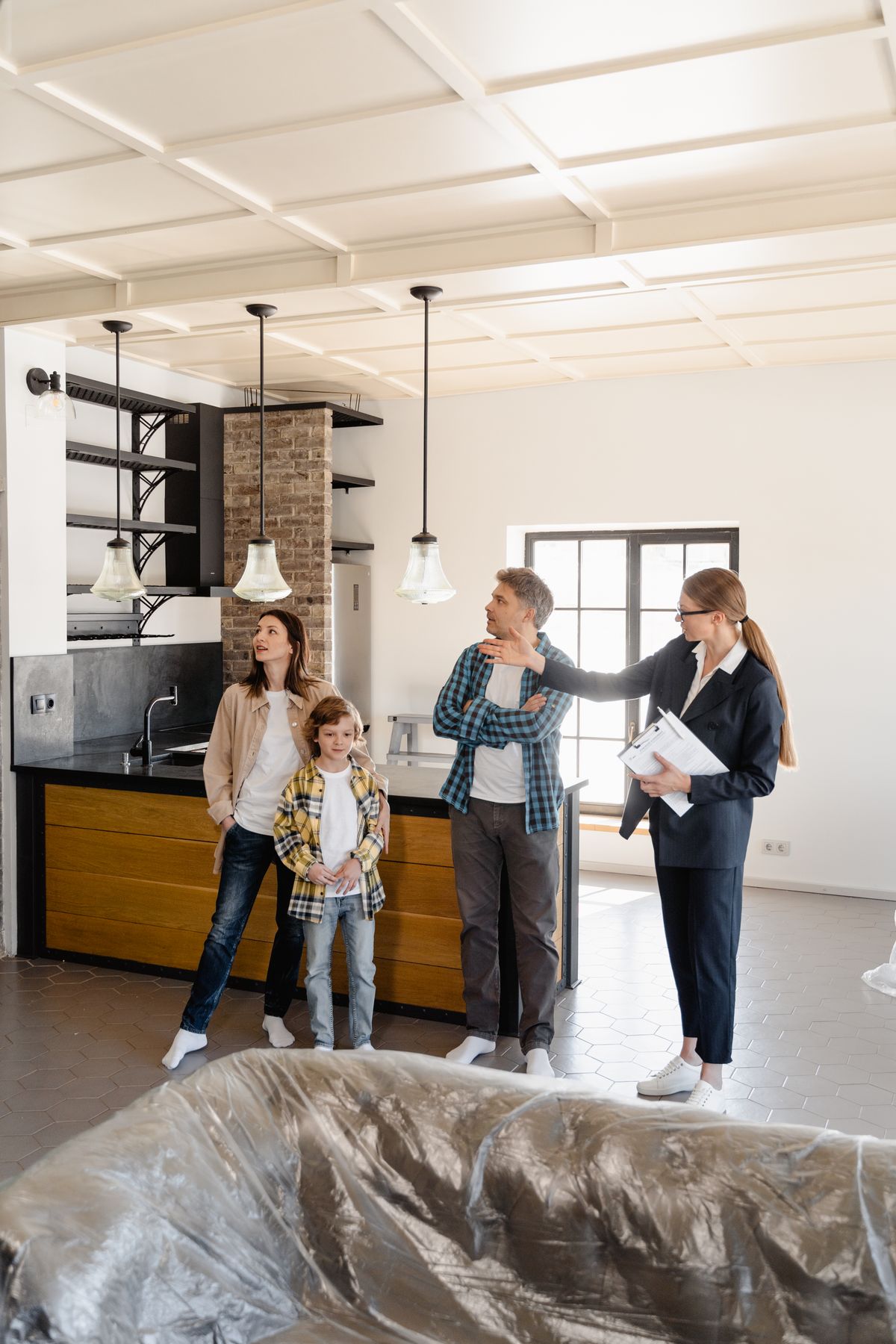A real estate agent showing a family through the kitchen of a new home