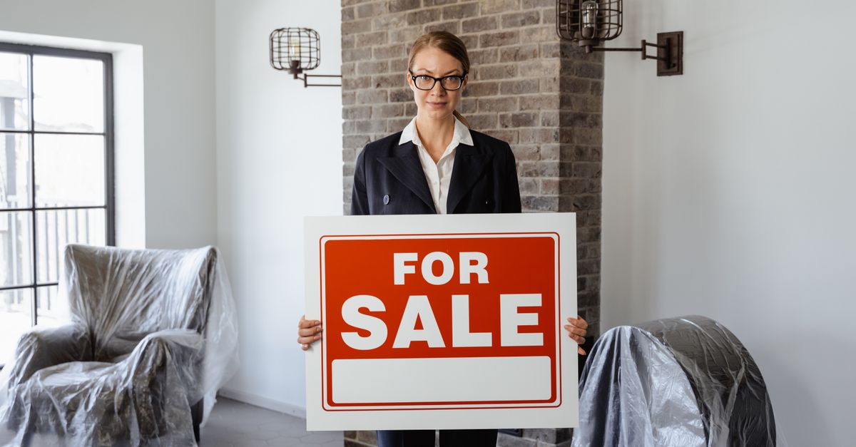For sale sign outside a Toronto condo building as a buyer weighs selling the pre-construction assignment at a loss