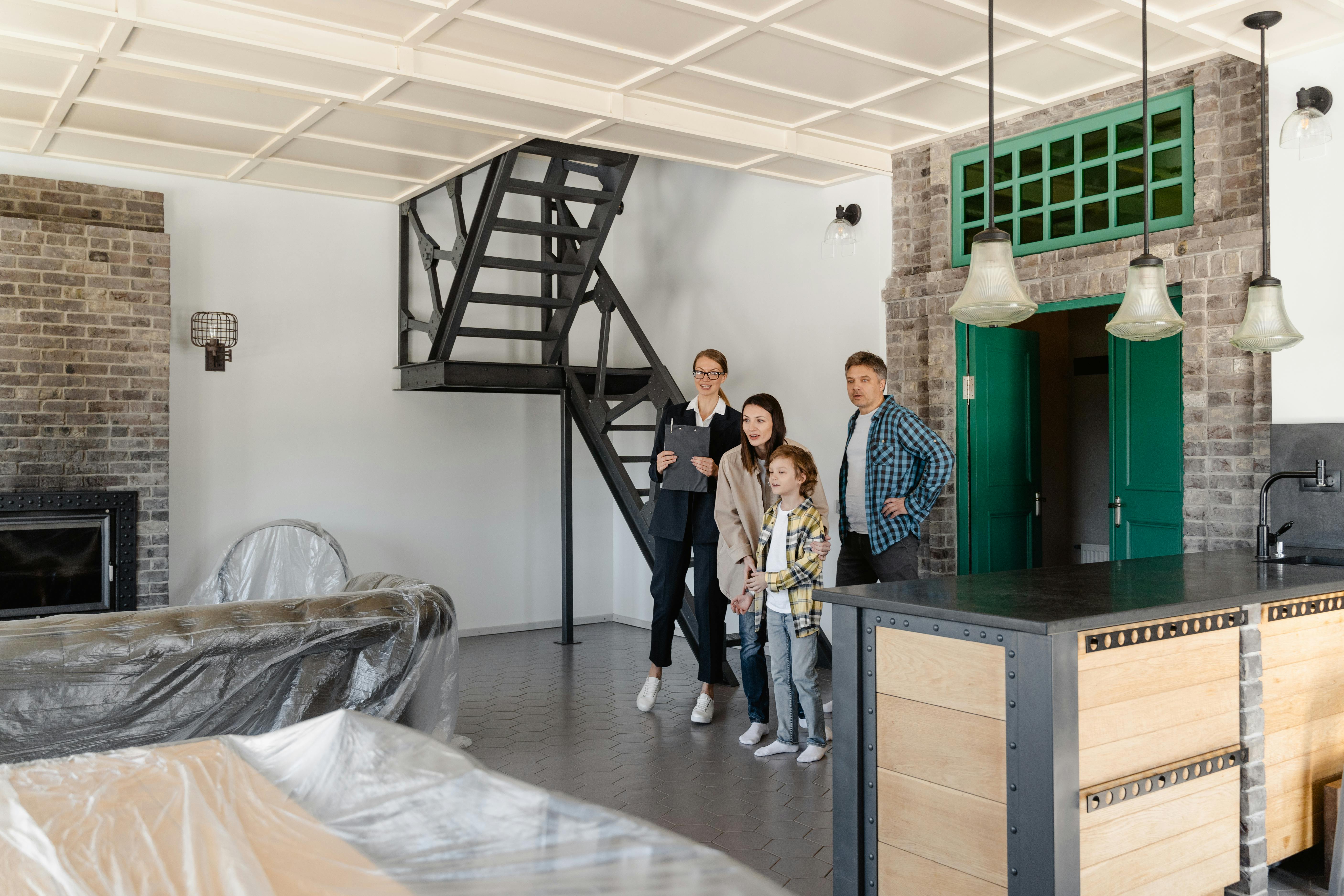 A family exploring a modern home with a real estate agent, featuring industrial interior design.