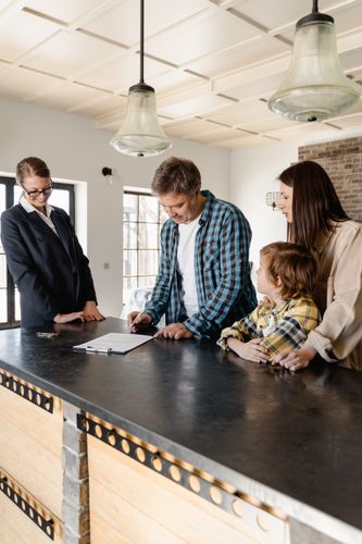 Couple reviewing home purchase documents with their agent