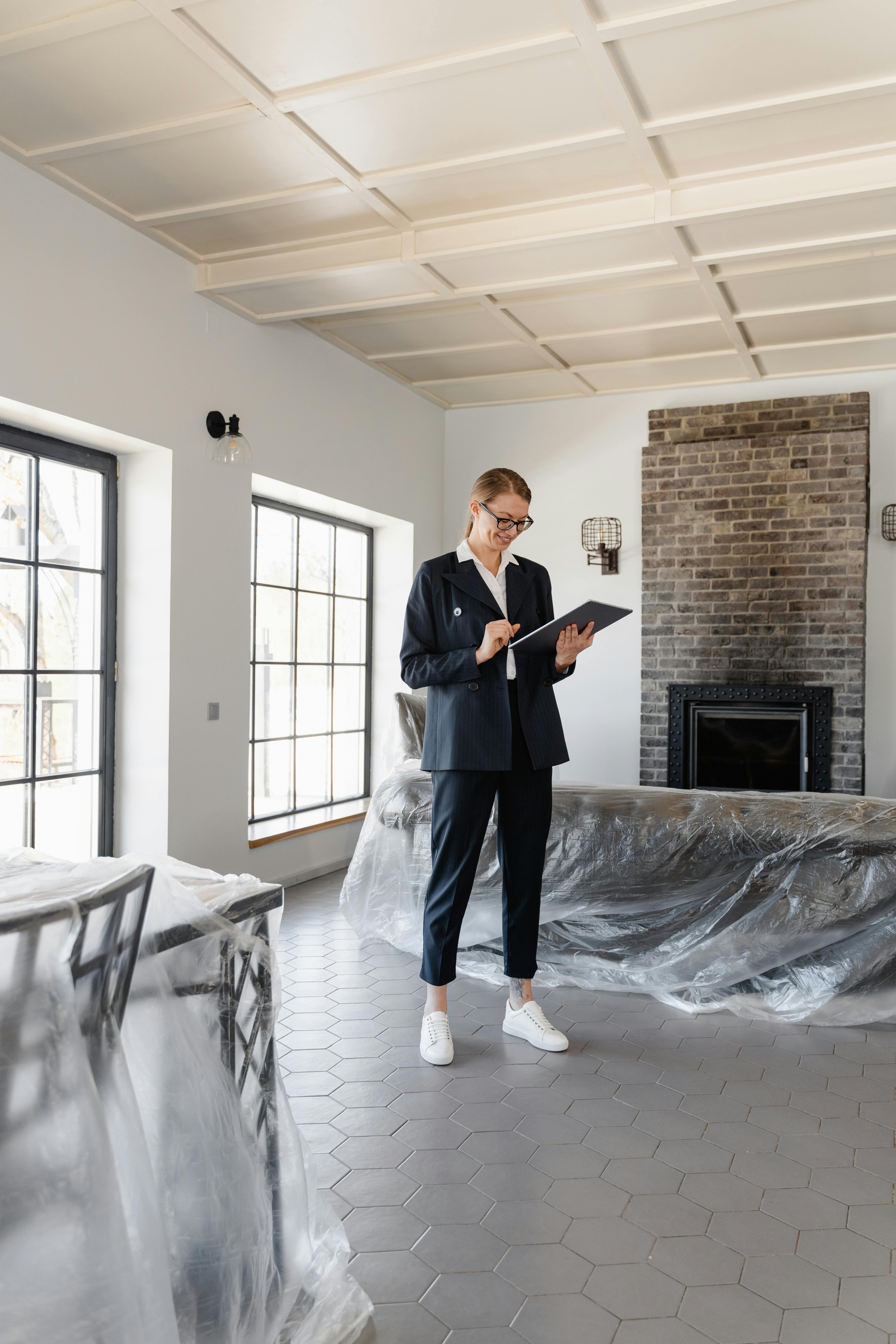 man in black suit standing near white table