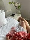 Woman relaxing on bed in morning