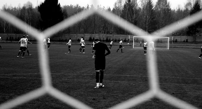 View of soccer players through goal net