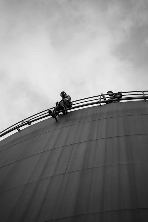 Man Standing behind Building Railing