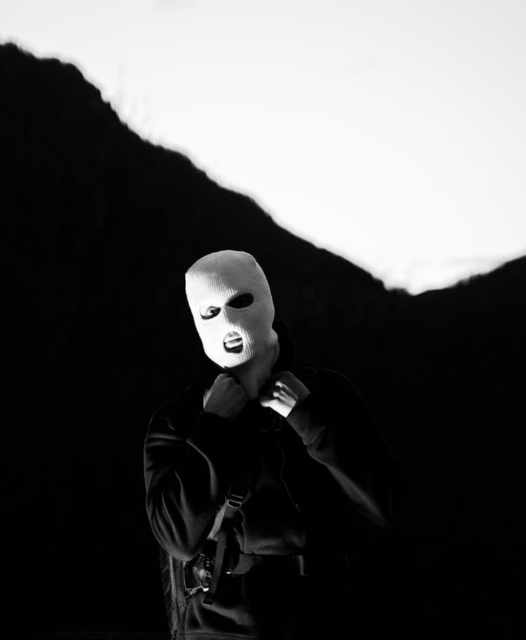 
A Grayscale Of A Person Wearing A Mask