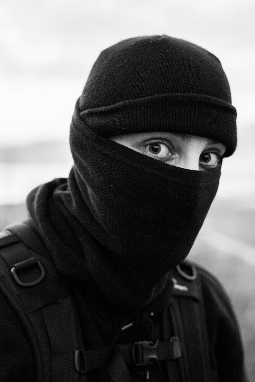 Grayscale Photo of Person Wearing Black Balaclava Face Mask