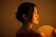 Dreamy Japanese woman with hand fan