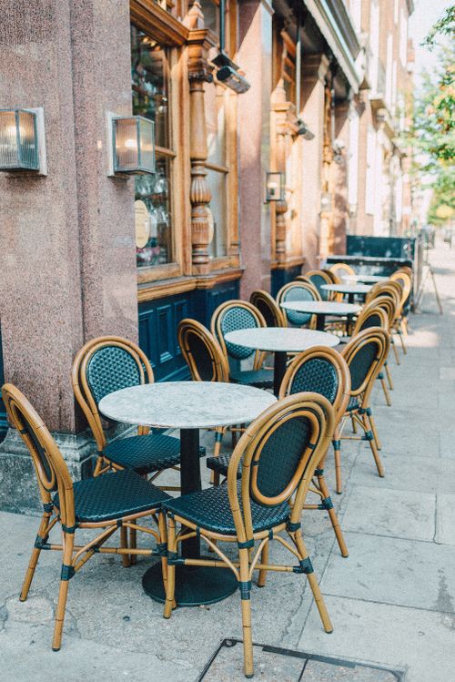 Free Exterior view of a quaint café with elegant outdoor seating in London. Stock Photo