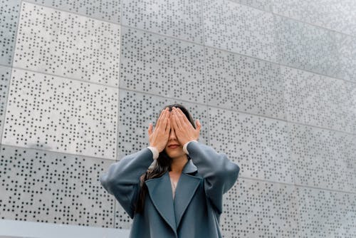 Free A Woman Covering Her Eyes with Hands Stock Photo