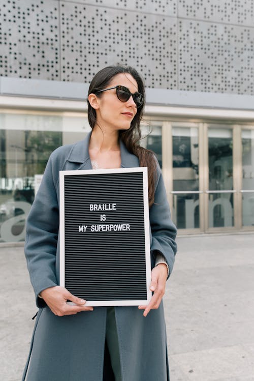 Free 
A Woman Wearing Sunglasses Holding a Letter Board Stock Photo