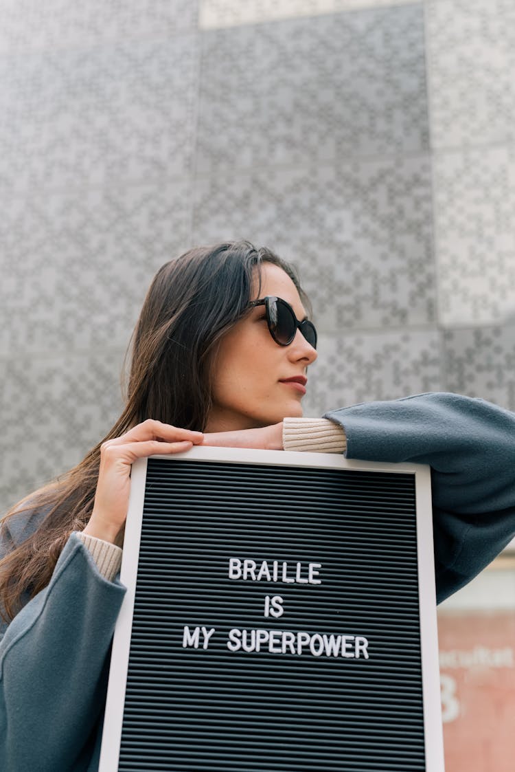 Person Leaning On A Letter Board