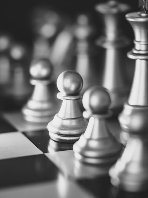 Free Artistic black and white shot of chess pieces on a board, perfect for strategy themes. Stock Photo