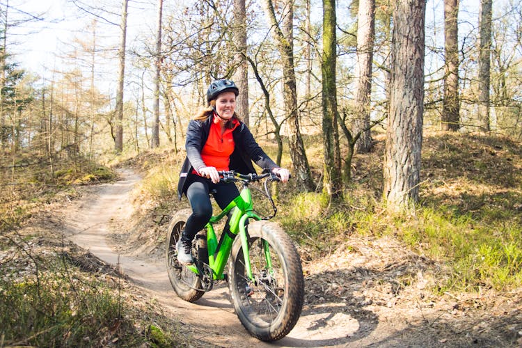 A Woman Biking In The Forest