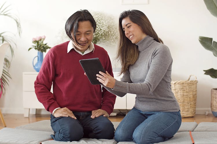 Photo Of A Couple Looking At A Tablet