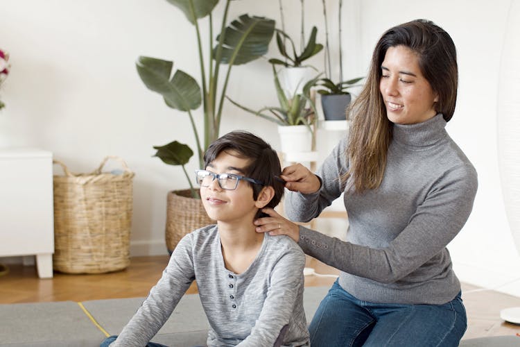 A Mother Brushing His Son's Hair