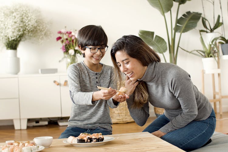 A Boy Feeding His Mother