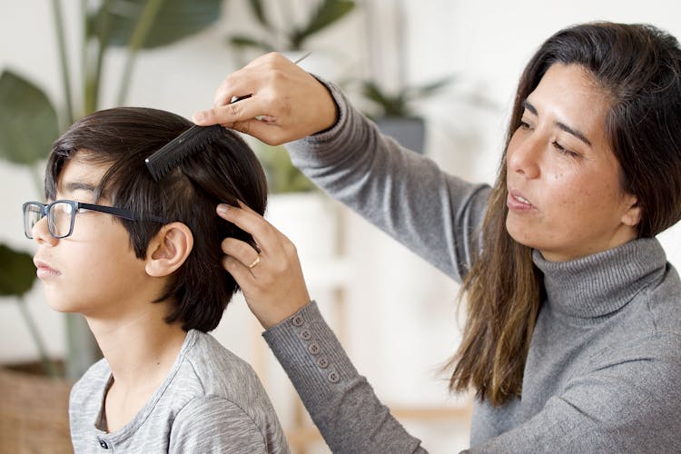 Mother Combing Her Sons Hair