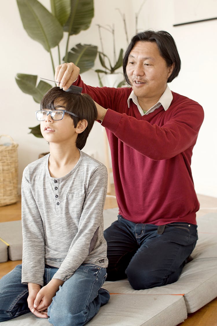 Father Combing The Hair Of His Son