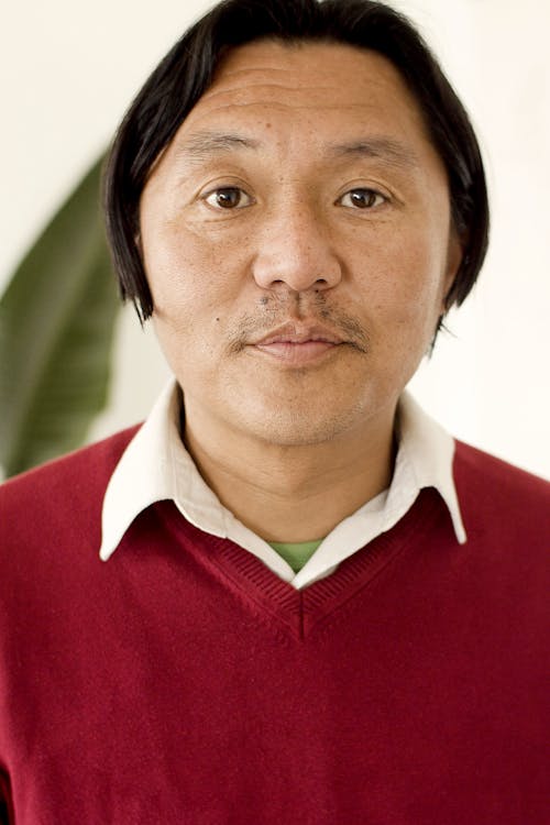Close Up Photo of a Man in Red Top