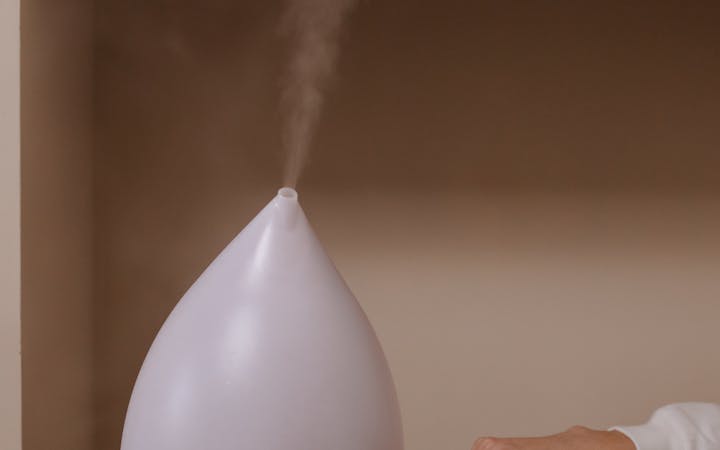 A modern humidifier releasing steam, enhancing ambient mood indoors.
