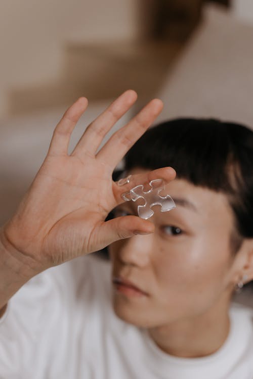 Woman Holding a Transparent Puzzle Piece