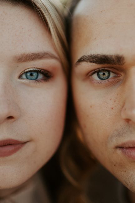 Intimate close-up portrait of a couple showing their striking blue eyes, capturing a moment of connection.