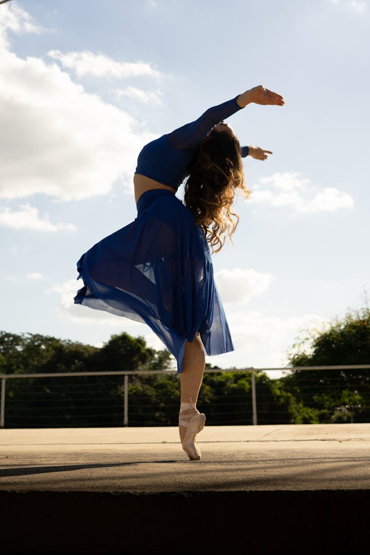 Woman In A Blue Skirt Dancing