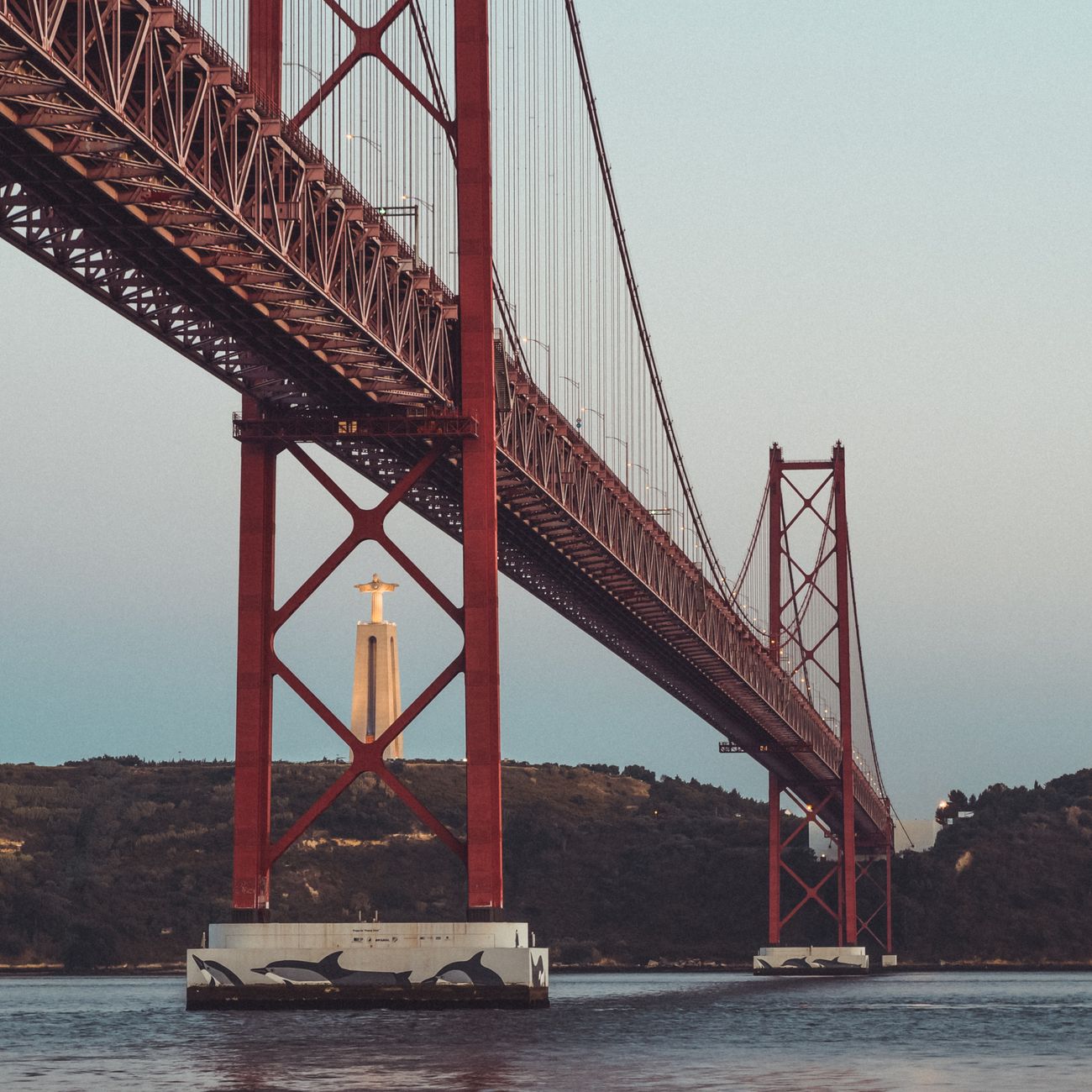 View of the 25 de Abril Bridge with Cristo Rei statue in Lisbon, Portugal.