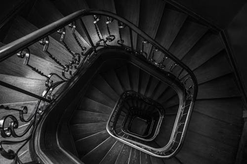 Grayscale Photo of a Spiral Staircase