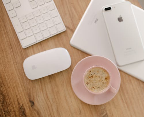 Free Overhead Shot of a Cup of Coffee Near a White Cell Phone Stock Photo